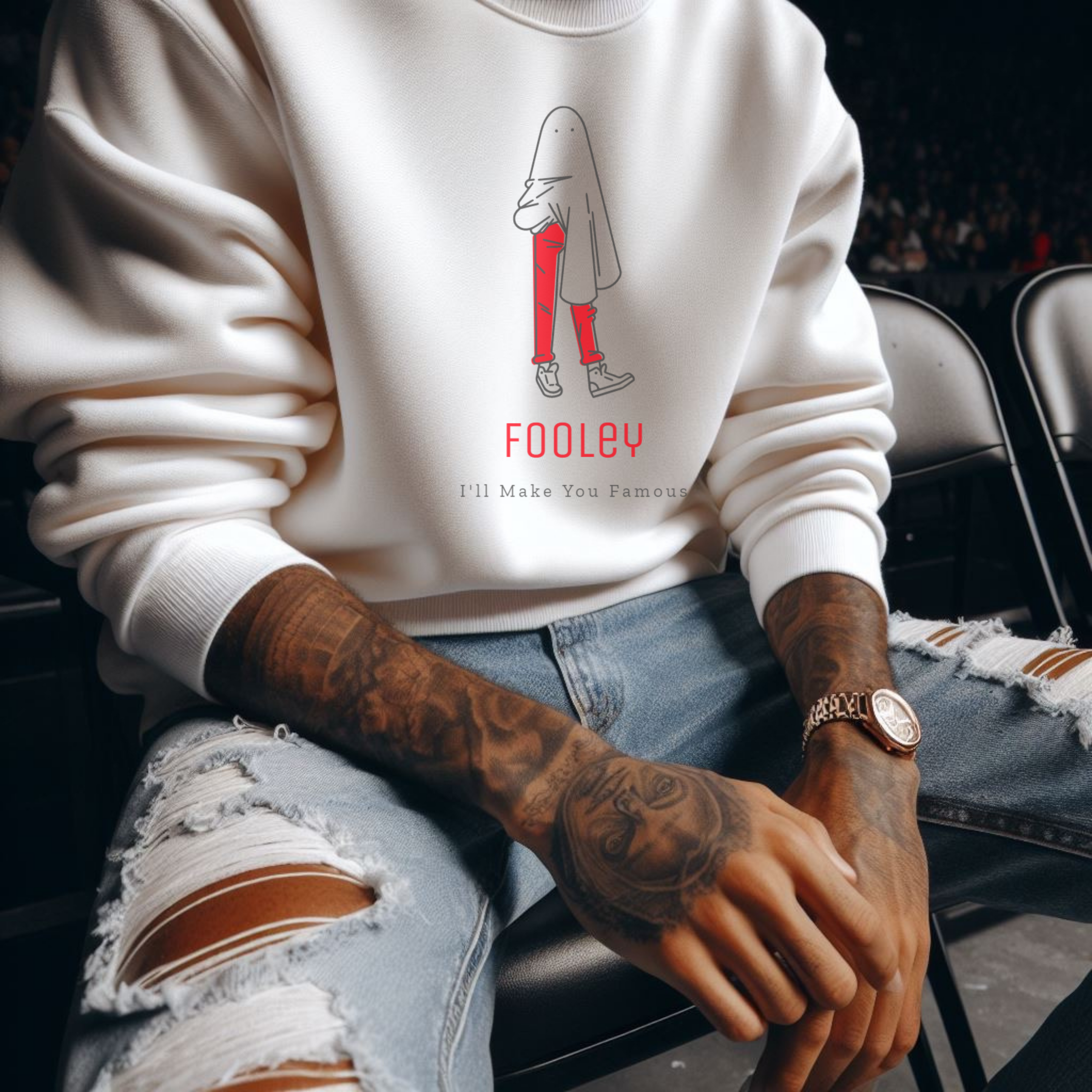 Male model sitting court-side at an NBA game, wearing white signature sweatshirt featuring ‘No Huddle Just Go’ Fooley design, a premium essential for any wardrobe.